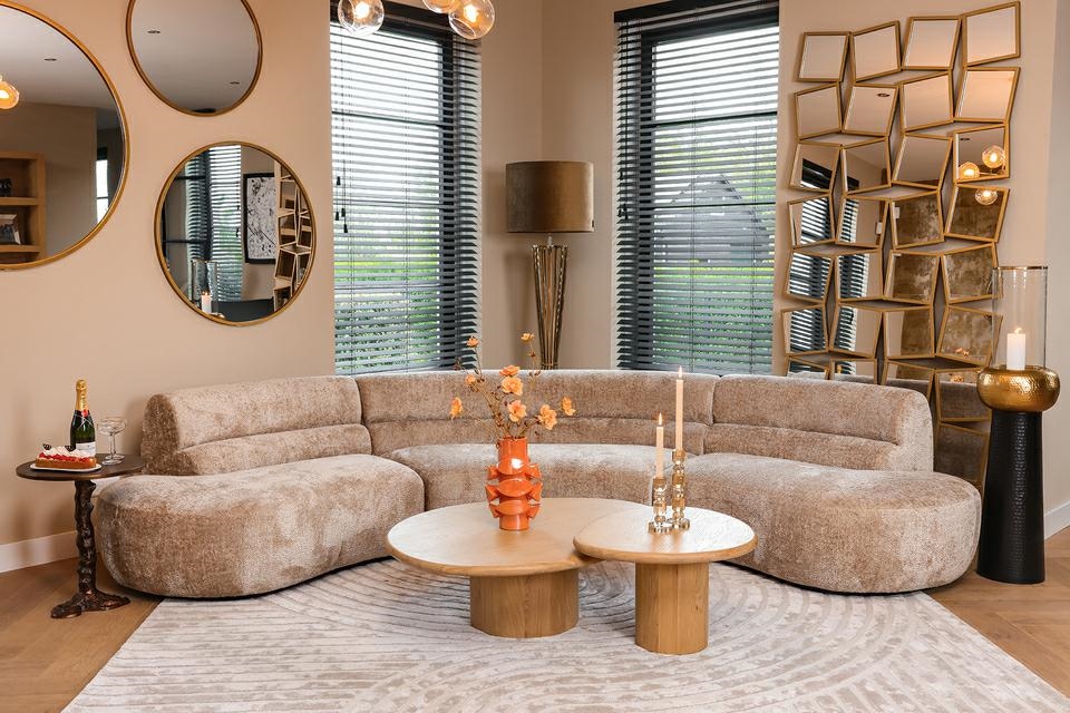 Elegancki salon w stylu glamour z beżową sofą i złotymi lampami